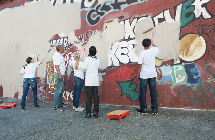 Volunteers painting over grafitti